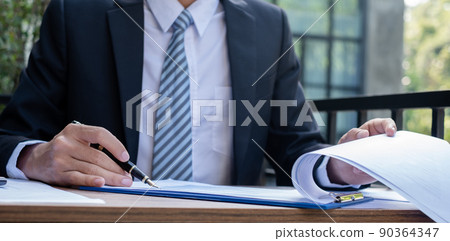 Young businessman financial market analyst sits at their desks and calculate financial graphs showing the results of their investments planning the process of successful business growth Young businessman financial market analyst sits at their desks and calculate financial graphs showing the results of their investments planning the process of successful business growth 90364347