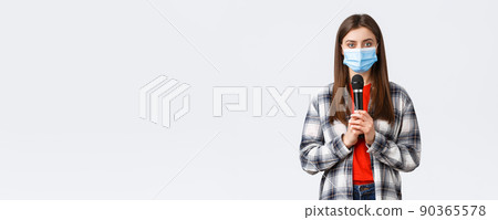 Coronavirus outbreak, leisure on quarantine, social distancing and emotions concept. Girl in medical mask performing song or stand-up, holding microphone want be heard, white background Coronavirus outbreak, leisure on quarantine, social distancing and emotions concept. Girl in medical mask performing song or stand-up, holding microphone want be heard, white background 90365578