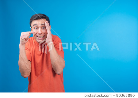 Ashamed man covering face and pointing away Ashamed man covering face and pointing away 90365890