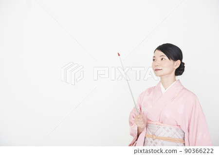 A woman in a kimono with a pointer 90366222