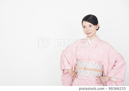 A woman in a kimono with her hands on her hips 90366235