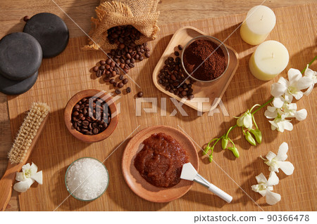A closeup view of coffee bean and powder decorated with wooden tray candles and flower in wooden background for exfoliating advertising , mixture of coffee and salt A closeup view of coffee bean and powder decorated with wooden tray candles and flower in wooden background for exfoliating advertising , mixture of coffee and salt 90366478