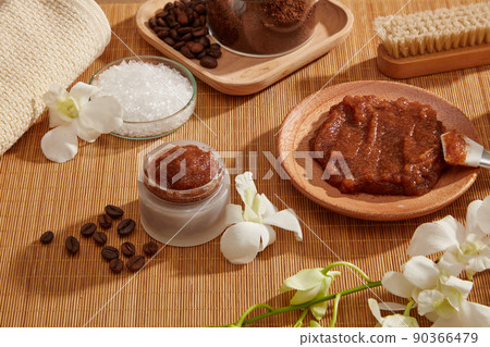 A closeup view of coffee bean and powder decorated with wooden tray candles and flower in wooden background for exfoliating advertising , mixture of coffee and salt A closeup view of coffee bean and powder decorated with wooden tray candles and flower in wooden background for exfoliating advertising , mixture of coffee and salt 90366479