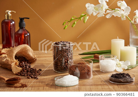 Close view of coffee and salt decorated with coffee pack and flower towel in wooden background for advertising  90366481