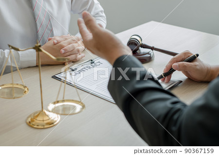 A man lawyer or a judge counseling clients about judicial justice and prosecution with scales, judges gavel, legal documents legal services concept A man lawyer or a judge counseling clients about judicial justice and prosecution with scales, judges gavel, legal documents legal services concept 90367159