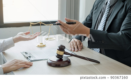 A man lawyer or a judge counseling clients about judicial justice and prosecution with scales, judges gavel, legal documents legal services concept A man lawyer or a judge counseling clients about judicial justice and prosecution with scales, judges gavel, legal documents legal services concept 90367160