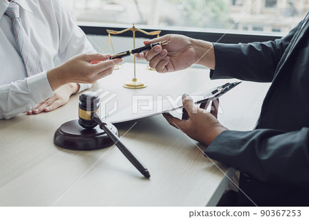 A man lawyer or a judge counseling clients about judicial justice and prosecution with scales, judges gavel, legal documents legal services concept 90367253