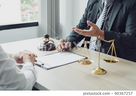 A man lawyer or a judge counseling clients about judicial justice and prosecution with scales, judges gavel, legal documents legal services concept A man lawyer or a judge counseling clients about judicial justice and prosecution with scales, judges gavel, legal documents legal services concept 90367257