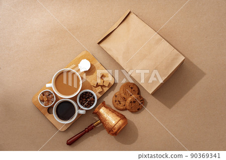 Top view of the wooden tray with coffee cup on beige background Top view of the wooden tray with coffee cup on beige background 90369341