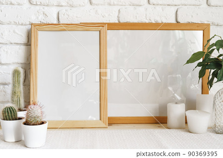 Square wooden photo frame and cactus plants on the table Square wooden photo frame and cactus plants on the table 90369395