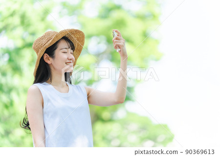 Women spraying sunscreen and insect repellent (smiles and faces) 90369613