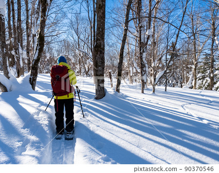 Snowshoe hiking on a sunny day (Hokkaido, Date City, Otaki Ward) 90370546