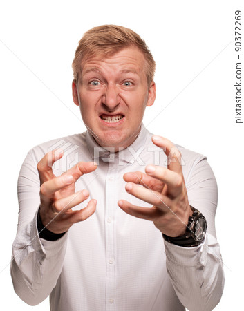 Imposing, young, blond man in a white shirt is grimacing while standing isolated on a white background 90372269