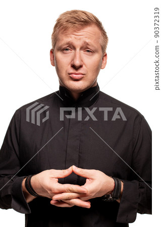Young blond man in a black shirt, watches and bracelet is making faces, isolated on a white background 90372319