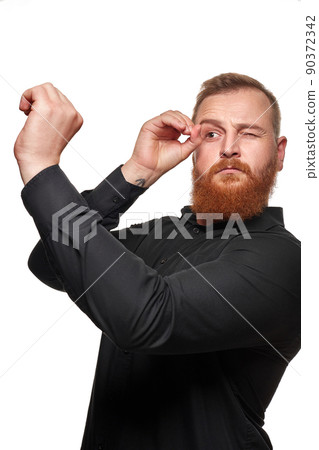 Portrait of a funny positive young man looking through a telescope on white background 90372342