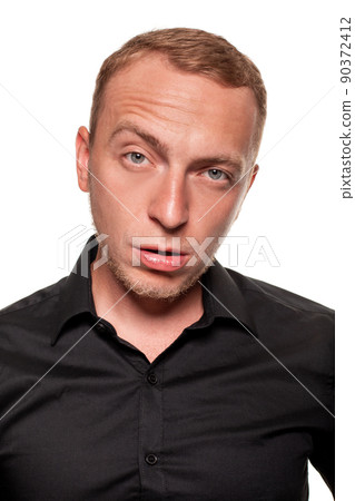 Handsome young blond man in a black shirt, isolated on a white background 90372412