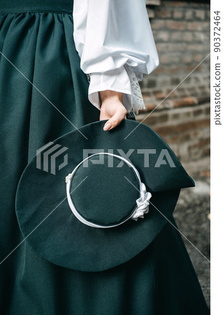 Green vintage hat 1800s early 1900s clothing in female hand. 90372464