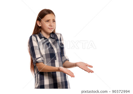 Beautiful teenage girl in a casual checkered shirt is posing isolated on white studio background. Beautiful teenage girl in a casual checkered shirt is posing isolated on white studio background. 90372994