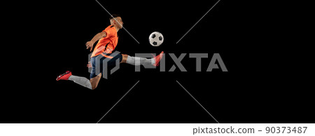 Flyer. Dynamic portrait of professional male football soccer player in motion isolated on dark background. Concept of sport, goals, competition, hobby, achievements Flyer. Dynamic portrait of professional male football soccer player in motion isolated on dark background. Concept of sport, goals, competition, hobby, achievements 90373487