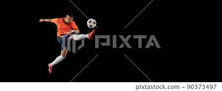 Flyer. Dynamic portrait of professional male football soccer player in motion isolated on dark background. Concept of sport, goals, competition, hobby, achievements Flyer. Dynamic portrait of professional male football soccer player in motion isolated on dark background. Concept of sport, goals, competition, hobby, achievements 90373497