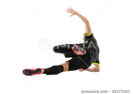 One professional male football soccer player doing sliding tackle isolated on white studio background. Concept of sport, goals, competition, hobby, achievements 90373505