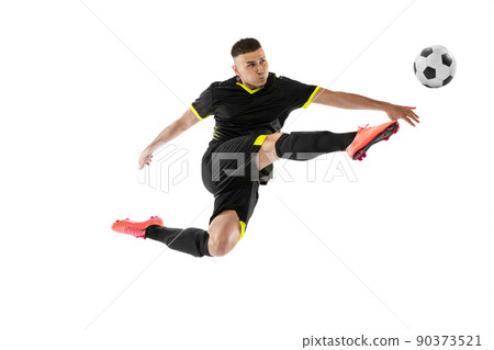 Dynamic portrait of professional male football soccer player training isolated on white studio background. Concept of sport, goals, competition, hobby, achievements 90373521