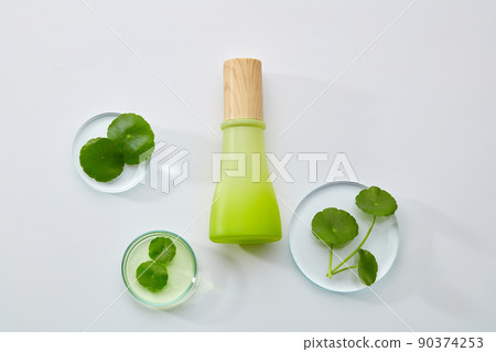 Cosmetic bottle containers with centella asiatica extract and scientific glassware. Research and develop natural organic beauty skincare product concept. Blank label for mockup. Top view 90374253