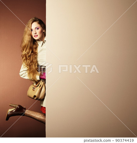 Photo young beautiful woman in a raincoat in interior 90374419
