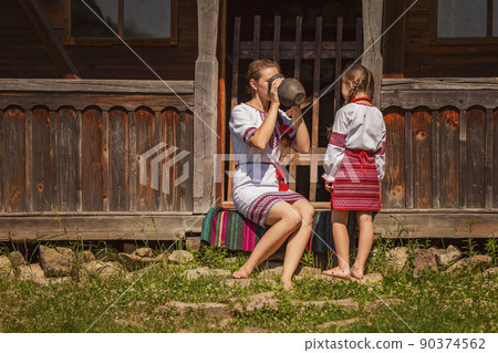 mother with daughter and jug 90374562