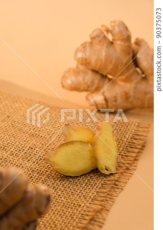 Fresh organic ginger rhizome root used in traditional medicines. Creative photo Earth tones natural background. Fresh organic ginger rhizome root used in traditional medicines. Creative photo Earth tones natural background. 90375073
