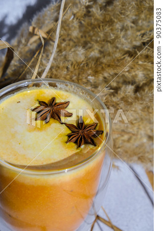 Pumpkin smoothie spiced latte. Anise stars. Autumn coffee with spicy pumpkin flavor seasonal hot drink. Fall Drinks for Halloween and Thanksgiving Pumpkin smoothie spiced latte. Anise stars. Autumn coffee with spicy pumpkin flavor seasonal hot drink. Fall Drinks for Halloween and Thanksgiving 90375083