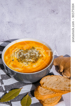 Homemade carrot ginger curcuma soup. Seasonal Pumpkin traditional soup with creamy silky texture. Healthy vegan clean eating. Seasonal spicy fall vegetables creamy pumpkin and carrot soup 90375084