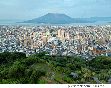 Aerial view of the evening view of Kagoshima city from the sky above Takeoka Park 90375438