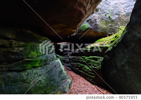 Selective focus, blurred background, passage between large stone rocks. Selective focus, blurred background, passage between large stone rocks. 90375955