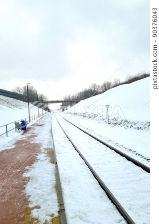 View of the empty platform of the railway station on a winter day. View of the empty platform of the railway station on a winter day. 90376043