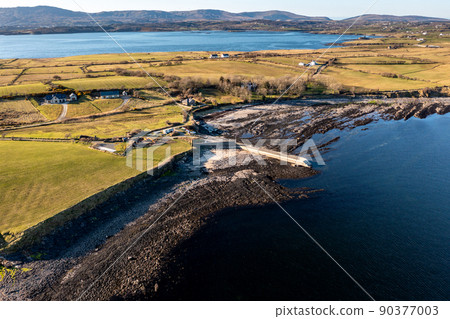 Aerial view of the amazing rocky coast at Ballyederland and pier by Dunkineely in County Donegal - Ireland Aerial view of the amazing rocky coast at Ballyederland and pier by Dunkineely in County Donegal - Ireland 90377003