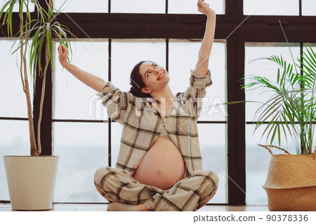 Meditation during pregnancy. Young calm tranquil pregnant woman in lotus pose Meditation during pregnancy. Young calm tranquil pregnant woman in lotus pose 90378336