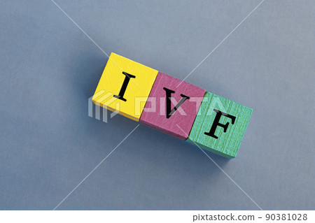 IVF acronym on colorful wooden cubes against blue background. 90381028