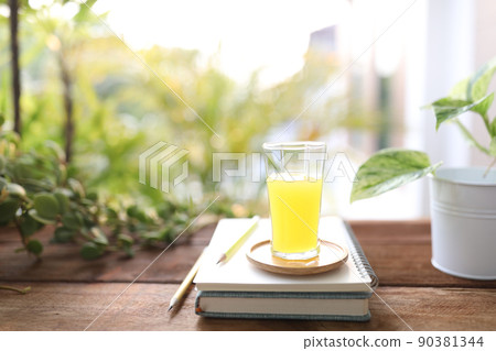 Pineapple juice and notebook on wooden table 90381344