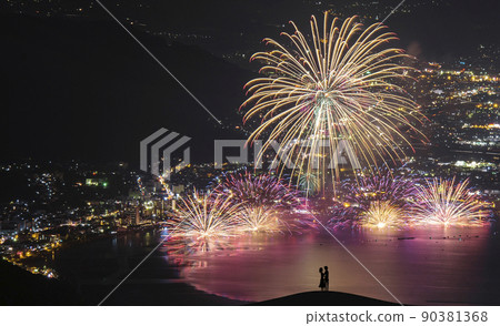 Silhouette of a couple kissing at a fireworks display. Image of summer love. 90381368
