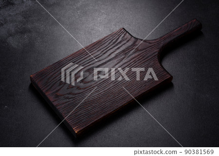 An empty plate with a knife, fork or spoon with a wooden cutting board An empty plate with a knife, fork or spoon with a wooden cutting board 90381569