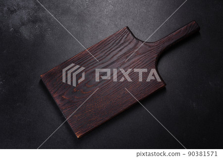 An empty plate with a knife, fork or spoon with a wooden cutting board 90381571