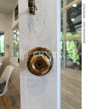 old gold stainless door knob or handle on wooden door 90381625