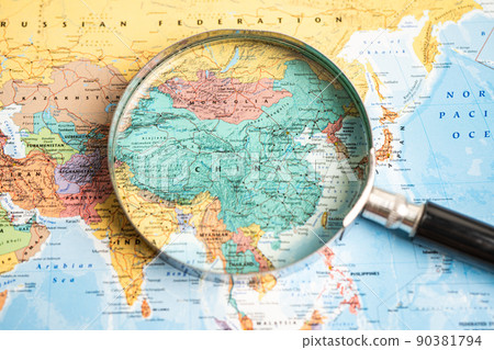 Bangkok, Thailand - May 01, 2022 China, Magnifying glass close up with colorful world map Bangkok, Thailand - May 01, 2022 China, Magnifying glass close up with colorful world map 90381794