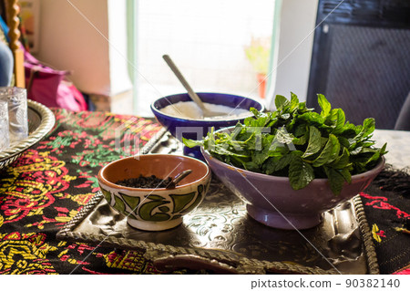 Preparation for making mint tea in Morocco: Lots of mint, tea leaves and sugar 90382140