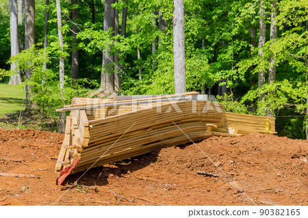 Framing of under construction wooden house building frame structure on new development 90382165