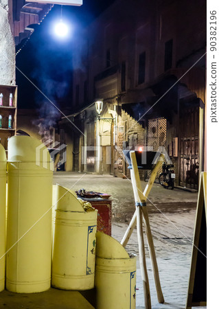 Night view of Marrakech, the city of Morocco, a flame lamp displayed at the storefront of a food store 90382196
