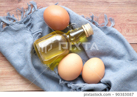 top view of egg and cooking oil on table top view of egg and cooking oil on table 90383087