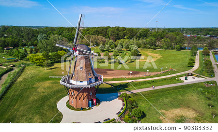 Aerial view of windmill on clean green lawn 90383332