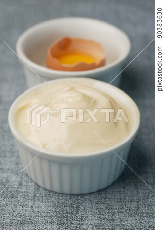 close up of Mayonnaise in container on table . close up of Mayonnaise in container on table . 90383630